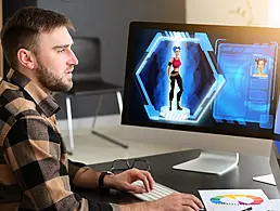 A woman at work is sitting, smiling at her laptop.