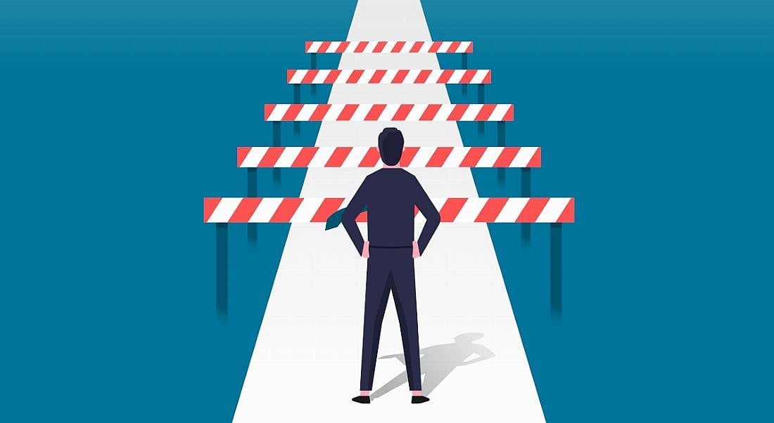 Man facing barriers on a path. Cartoon inaccessibility concept.