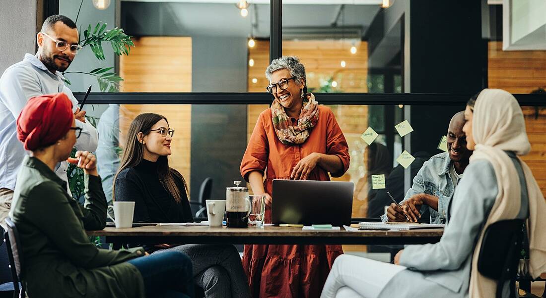 People from different age groups having a meeting in a modern office in the workplace.