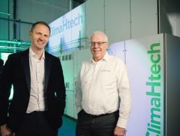 Mark Hutchinson, CEO of Hutchinson Engineering, and George McKinney, of Invest NI, standing in a manufacturing warehouse.