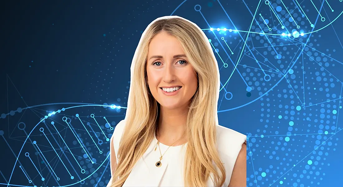 A woman smiles at the camera against a blue background showing DNA.