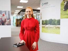 A professional woman in business attire is smiling into the camera in an office setting at MSD, Dublin.