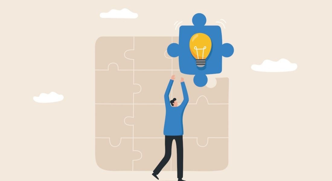 A cartoon of a person putting a blue jigsaw piece into a beige coloured jigsaw in a missing piece of the puzzle concept. There is a light bulb in the blue jigsaw piece.