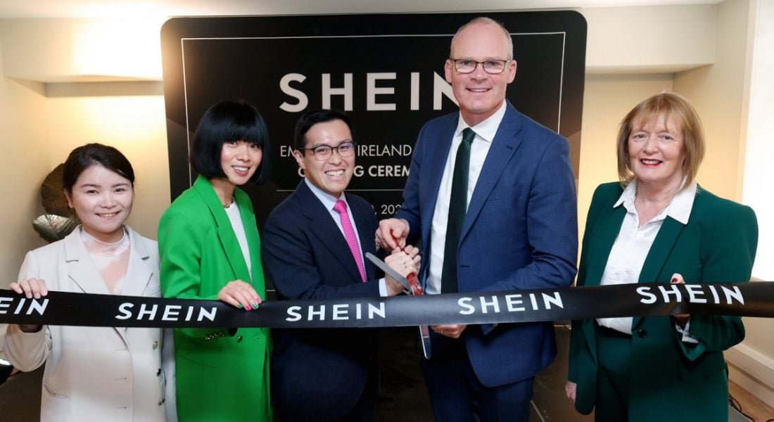 Five people at the official opening of Shein's new Dublin office holding a ribbon.