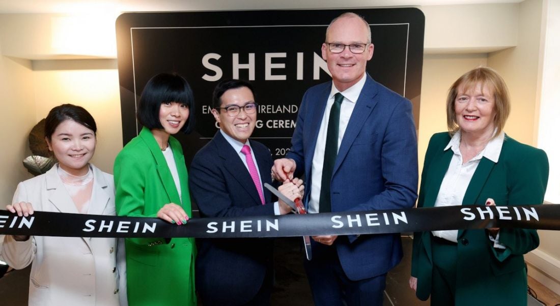 Five people at the official opening of Shein's new Dublin office holding a ribbon.