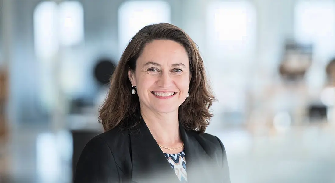 A woman smiles at the camera in an office setting. She is Marie-Louise de Smit, a cyber insurance specialist at Aon.