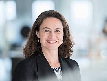 A woman smiles at the camera in an office setting. She is Marie-Louise de Smit, a cyber insurance specialist at Aon.