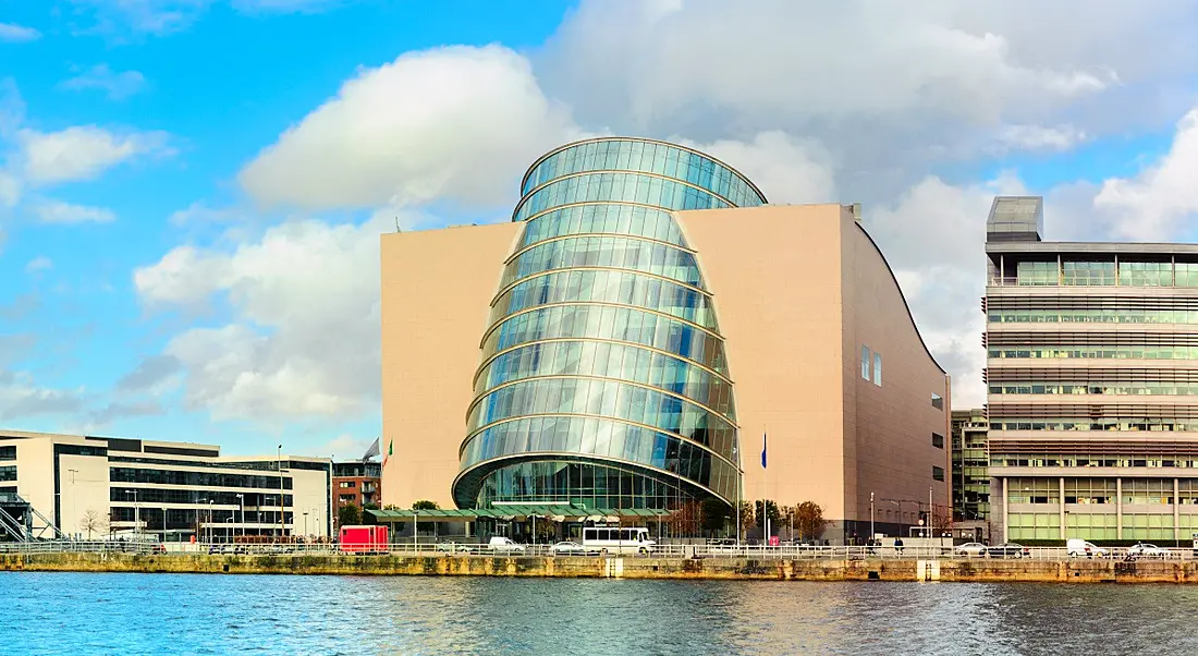 Dublin Convention Centre building visible across the Liffey alongside other buildings and a streetscape in the distance.