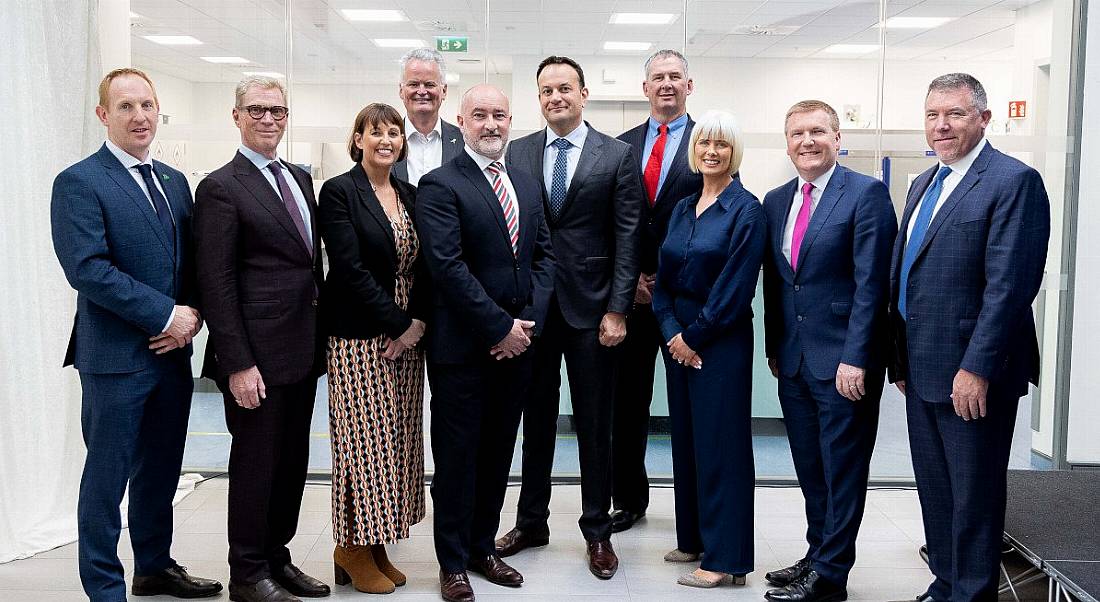 A group of ten people standing together in a bright white room at the opening of BioMarin Cork's new expansion.