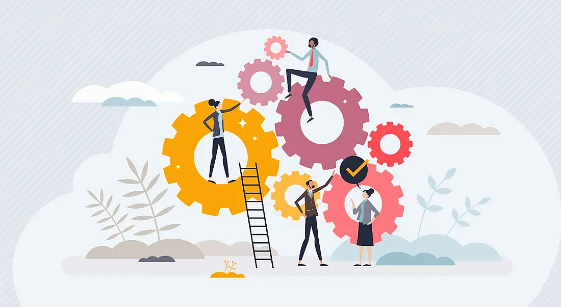 An illustration of a workforce sitting atop various sizes of cogs, symbolising teamwork and development.