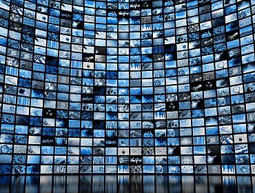 A large wall full of screens showing various images. Used as a concept for media regulation.