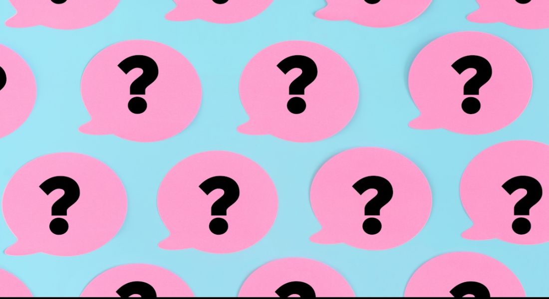 Pink speech bubbles with black question marks on them on a blue background.