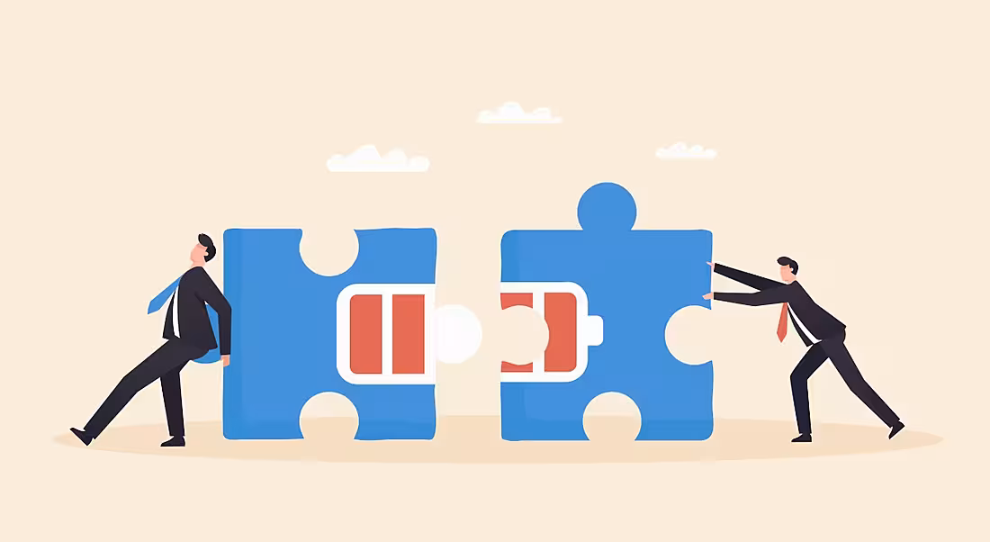Cartoon showing two workers pushing together blue jigsaw pieces with battery levels on them in a burnout recovery concept.