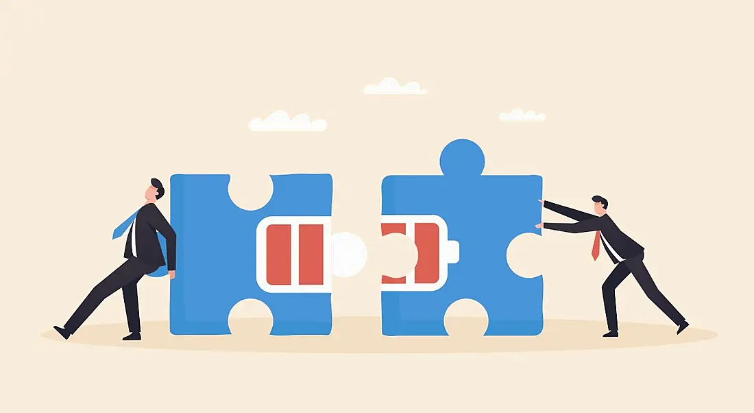 Cartoon showing two workers pushing together blue jigsaw pieces with battery levels on them in a burnout recovery concept.