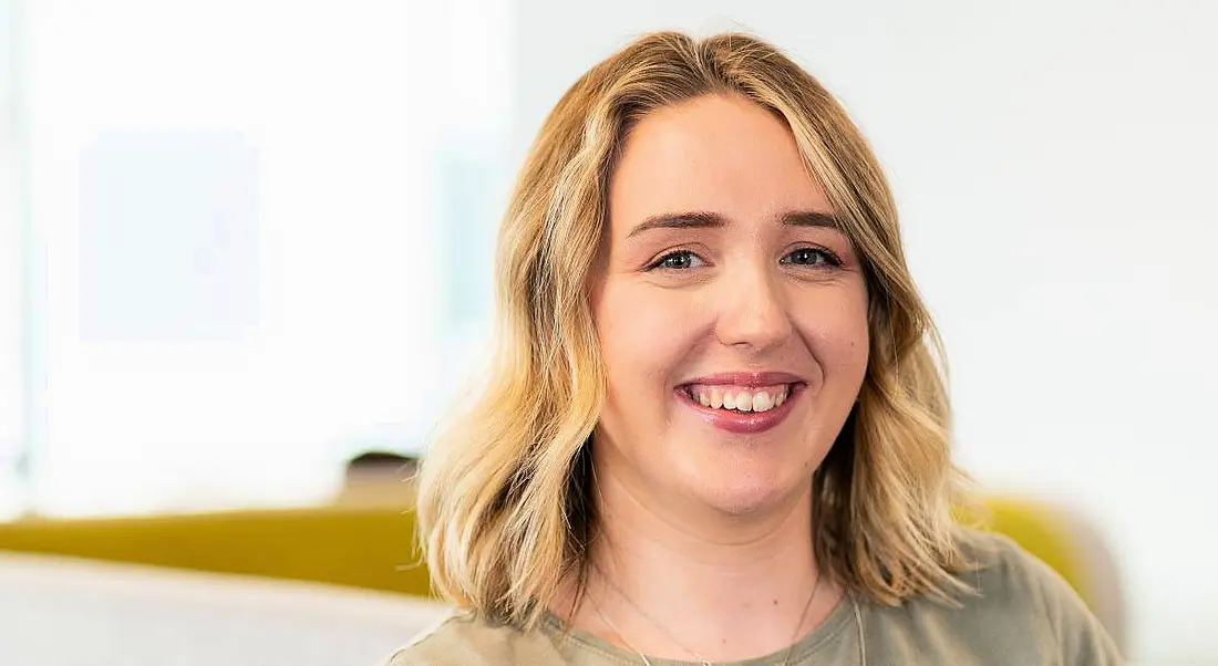 A woman smiles at the camera with a light, brightly lit background behind her. She is Antonia Blankenberg, a GIS consultant at Esri Ireland.