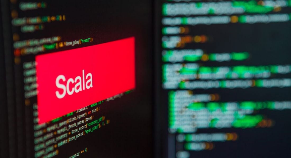 Scala logo on a screen superimposed on lines of code.