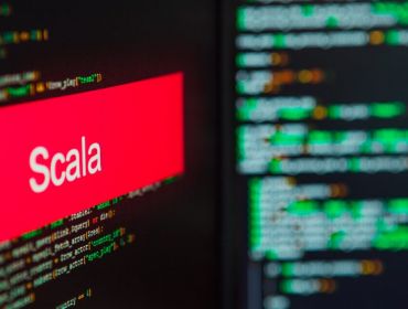 Scala logo on a screen superimposed on lines of code.