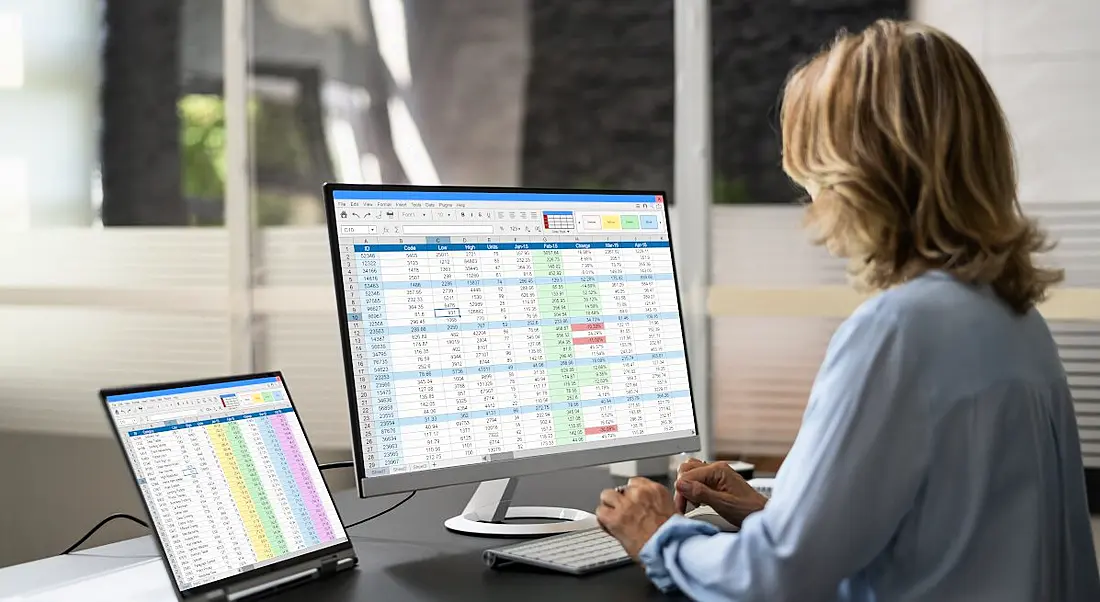 Woman in data science using a computer with a data science program open on it.