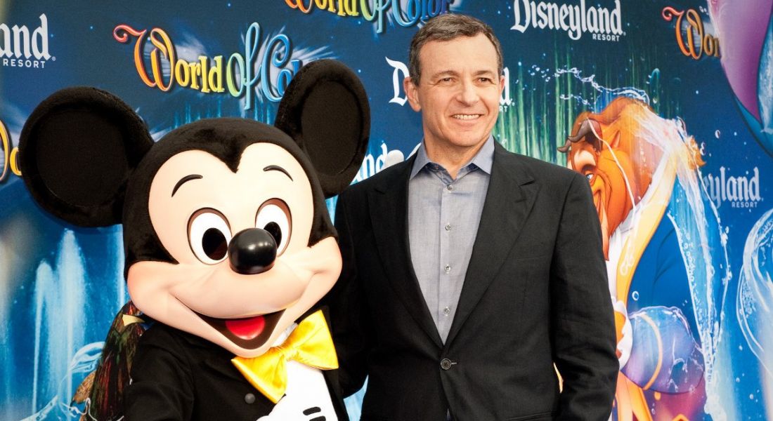 Disney CEO Bob Iger in 2010 at a premiere standing beside Mickey Mouse.