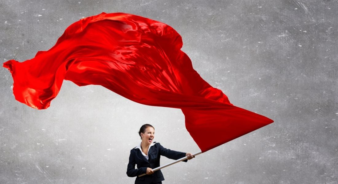 A businesswoman waving a huge red flag.