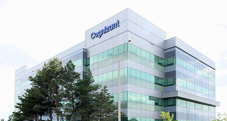 A tall building with the Cognizant logo on top, with a grey sky in the background.