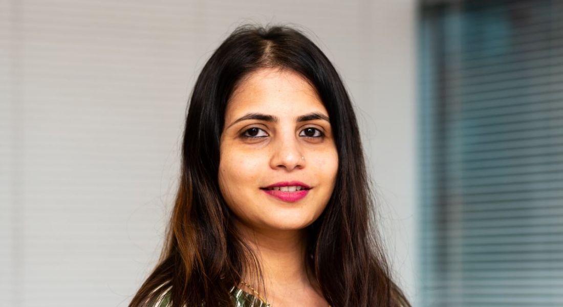 A woman stands smiling at the camera. She is Sonam Chougule, a senior data consultant at BearingPoint Ireland.