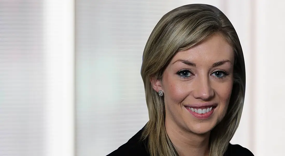 A headshot of Laura White of KPMG against a beige background.