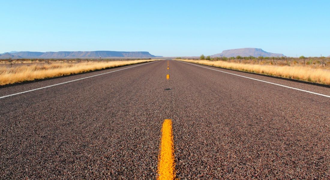 A long straight road in a desert symbolising employers planning for the road ahead.