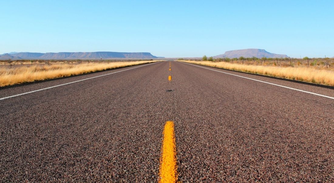 A long straight road in a desert symbolising employers planning for the road ahead.