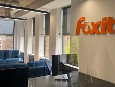 A picture of an office space with the Foxit logo on the wall.