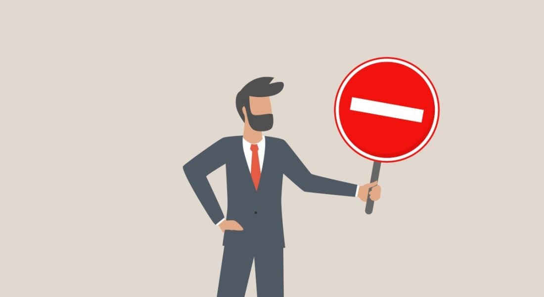 Cartoon of a remote worker holding a red sign vetoing a return to the office. There is a beige background behind him.