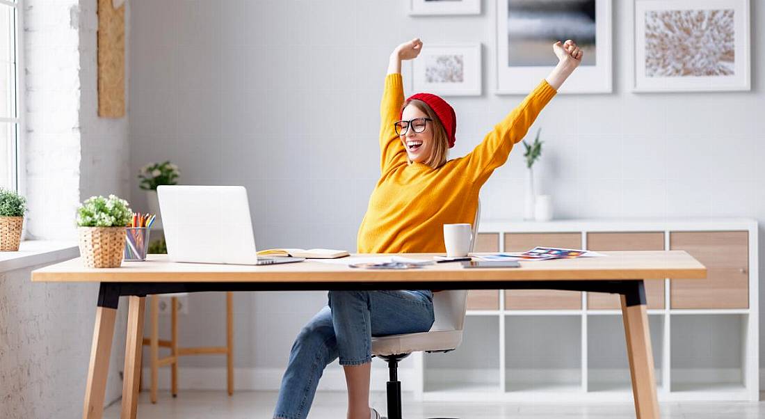 Young worker leaning back in her chair experiencing job satisfaction.