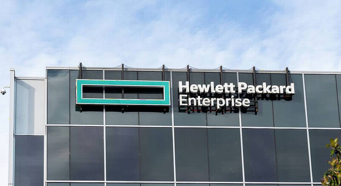 The outside of a large grey office building with HPE branding on it.