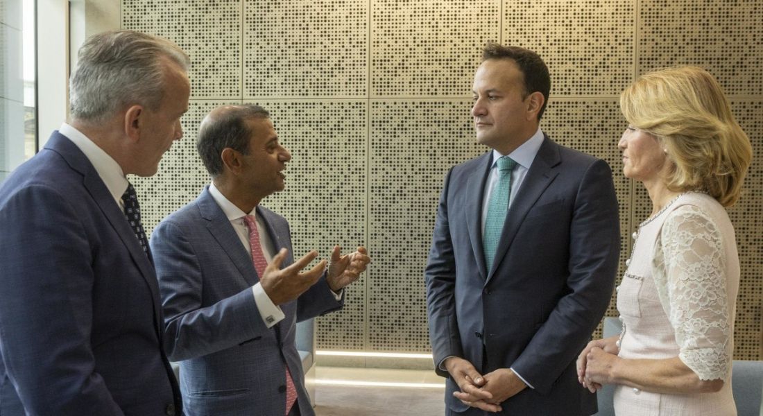 Two men from EXL, Mary Buckley from IDA Ireland and An Taoiseach Leo Varadkar, TD, stand in a semi circle chatting.