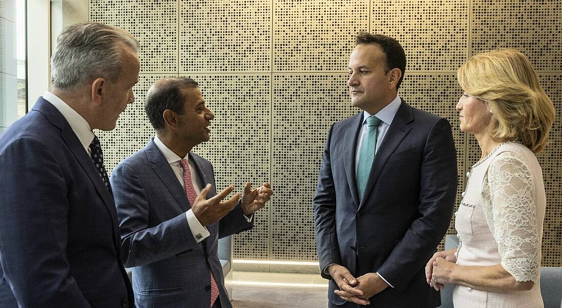 Two men from EXL, Mary Buckley from IDA Ireland and An Taoiseach Leo Varadkar, TD, stand in a semi circle chatting.