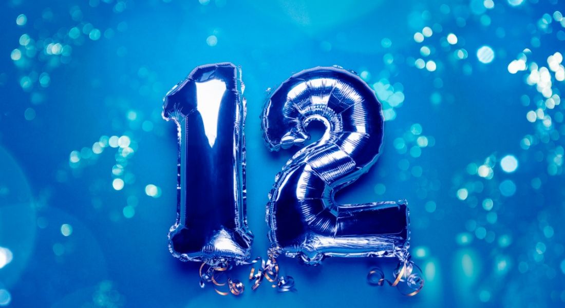 The number 12 in blue balloons on a blue background.
