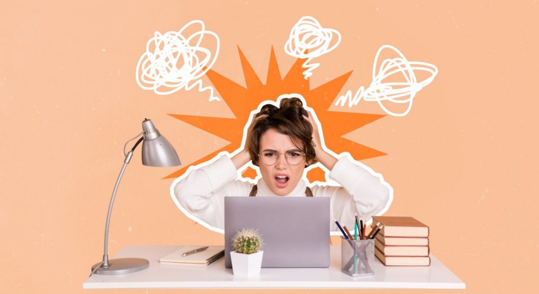 Collage of a young woman clutching her head as if she is experiencing cognitive overload. She is seated at an office desk with a laptop and lamp. The background behind her is pastel orange.