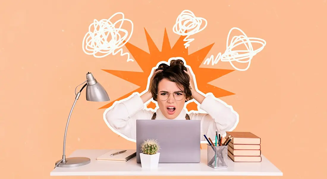 Collage of a young woman clutching her head as if she is experiencing cognitive overload. She is seated at an office desk with a laptop and lamp. The background behind her is pastel orange.