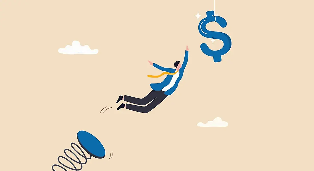 A cartoon showing an employee jumping off a spring trying to catch a dollar sign floating in the air in a pay raise concept.