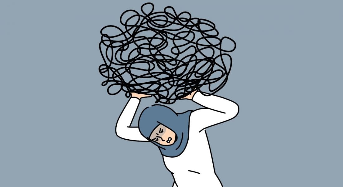 Cartoon of a stressed out worker crouching under the weight of a heavy workload, signified by a large black scribble over her head.