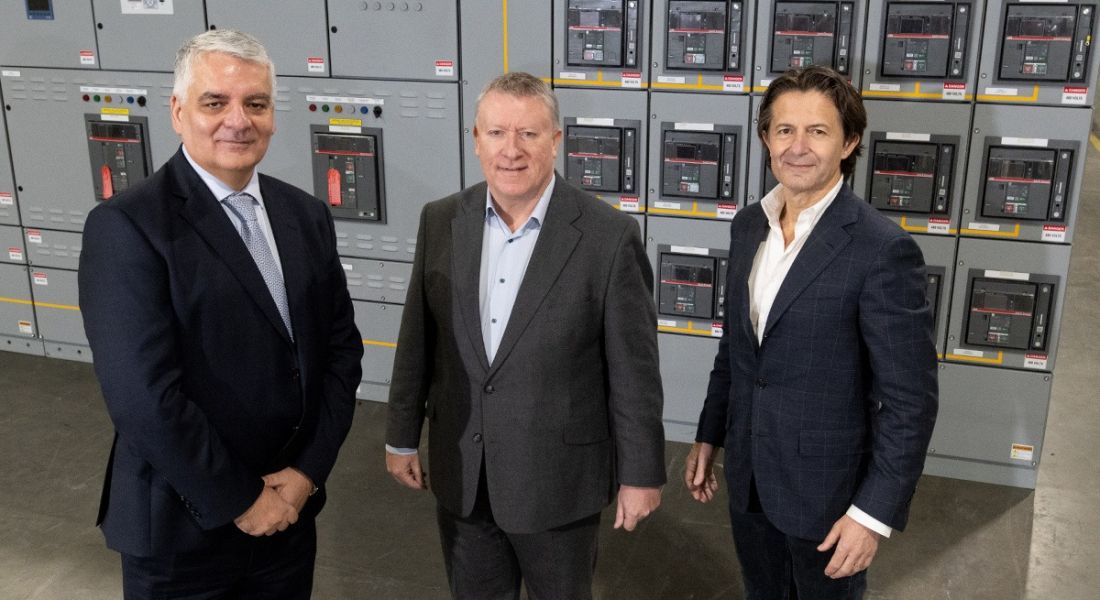 Three men at the jobs announcement for Vertiv in Derry standing in front of a data centre.