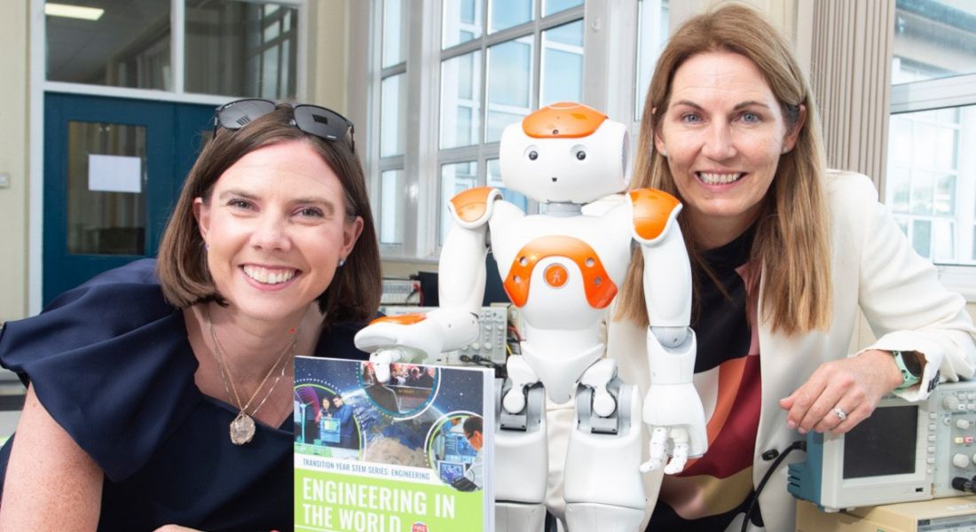 Susan Hayes Culleton and Marguerite O'Sullivan pictured with their book Engineering in the World and a robot.