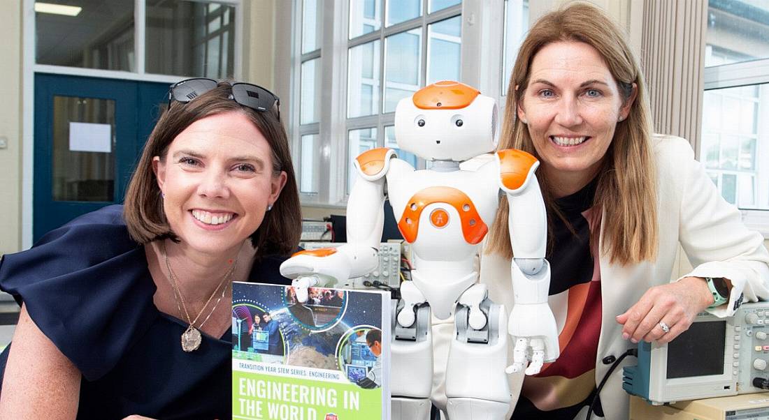 Susan Hayes Culleton and Marguerite O'Sullivan pictured with their book Engineering in the World and a robot.