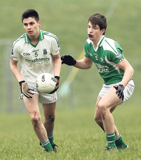 Looking ahead: Ilen Rovers Daniel ODriscoll breaks out of defence with the ball, as Dohenys Jamie Carroll closes in, during the U21 A quarter-final at Aughaville on Sunday.