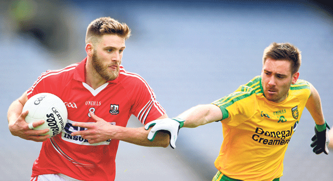 In control: Corks Eoin Cadogan holds off the challenge of Martin Reilly, Donegal, during Sundays Allianz Football League semi-final in Croke Park.