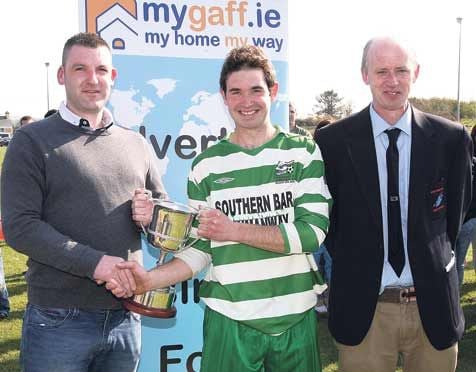 Captain fantastic: Brian ODonovan, competiition sponsor, presents the www.mygaff.ie Cup to Jerry McCarthy, captain of the Dunmanway team. On the right is TJ ODonovan, West Cork League Chairman. 