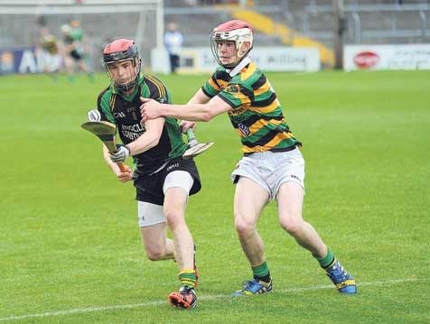 Darren McCarthy of Ballymartle, in possession, keeps his eye on the ball as Dave Noonan, Glen Rovers, at Pairc Ui Rinn during their sides senior hurling championship first round clash on Saturday last.
