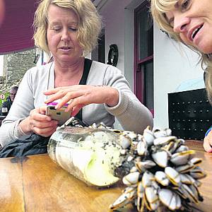 Bridget Healy and Philomena Flynn examine the bottle they found on Long Strand.