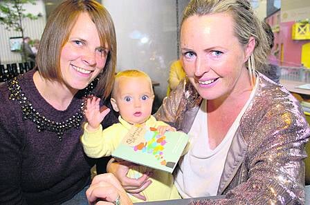 Eight-months-old Beau Montgomery-Callaghan admires the programme for the 2015 Skibbereen Arts Festival with her mum, Susan Montgomery from Clonakilty, and Sarah Ruttle, Ballydehob, at the festival launch at Kalbos Uillinn on Tuesday evening. The Southern