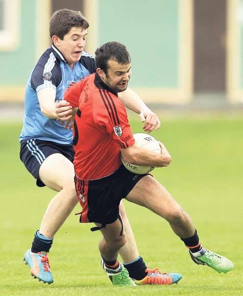 Denis McSweeney of St Colums breaks past Barryroes David Kiely during the Rowa-Rowex Pharma JAFC round three game at Ballinacarriga on Saturday evening